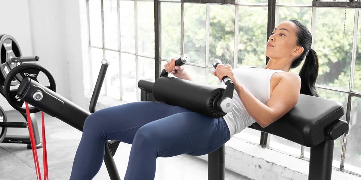 Woman performing a hip thrust on a glute drive machine