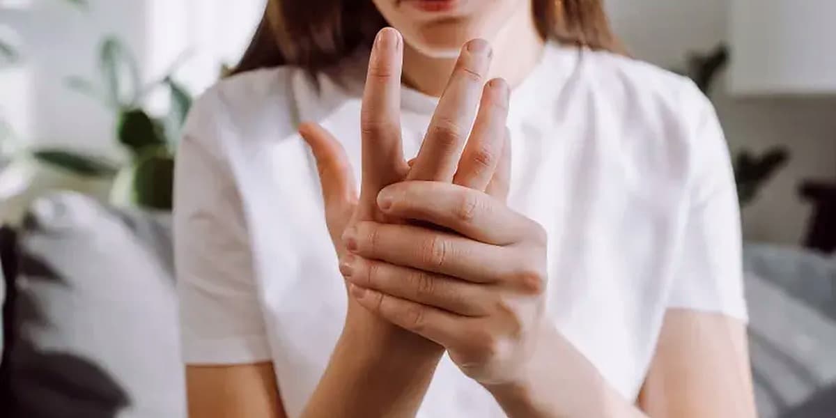 Close up of hands in clinical assessment, illustrating the joint examination relevant to rheumatological conditions